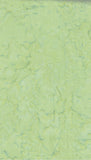 A close-up of a light yellow-green cotton batik fabric with subtle darker green veining and no visible product form, person, or environment.