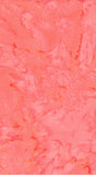 A close-up of a pink and coral cotton batik fabric with marbled, fluid-like variations throughout.