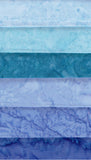 Six Fat Quarters of batik cotton shades of light blue, turquoise, teal, lavender, and deep blue.
