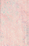 A close-up of a light pink cotton batik fabric with scattered small blue, teal, and lavender polka dots.