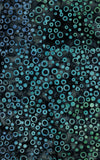 Patterned cotton batik fabric with blue and green circles on a black background