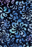 A close-up of a batik fabric pattern featuring abstract, swirling paisley-like motifs in shades of blue, light teal, and lavender on a dark navy watercolor background.