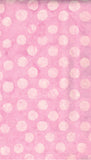 Pink cotton batik fabric with a pattern of light pink watercolor-style polka dots.