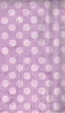 Purple cotton batik fabric with a white polka dot pattern, filling the entire frame.