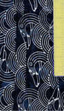 Fabric with white dolphin pattern on a blue background, next to a yellow ruler.