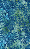 A close-up of a batik fabric pattern featuring blue, teal, and green floral and leaf motifs.