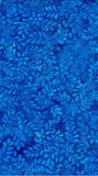 A close-up of a blue batik fabric with a repeating leafy vine pattern in various shades of blue.