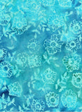 A close-up of a blue and turquoise patterned cotton batik fabric featuring a repeating hand-drawn hexagonal floral and leaf motif.