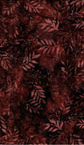 A close-up of a batik fabric pattern featuring dark reddish-brown and black leaf silhouettes.
