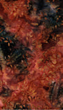 Abstract botanical pattern with overlapping leaves and foliage in warm red, orange, brown, and dark charcoal tones on cotton batik fabric