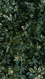 Patterned cotton batik fabric with green and brown leaves on a dark background