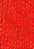 A close-up of a bright red fabric with an all-over pattern of small metallic gold and silver reflective dots.