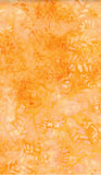A close-up of a warm orange and yellow batik fabric pattern with a subtle leafy texture.