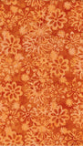 Pattern of flowers on a textured gold cotton batik fabric background