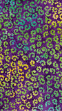Colorful pattern with green and yellow shapes on a purple background cotton batik fabric