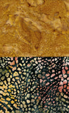 Two batik fabric swatches shown side by side: the top is a mottled mustard yellow and tan pattern, and the bottom is a black base with a dense multicolor spotted motif in cream, pink, yellow, and green.