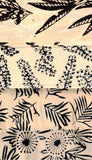 Patterned batik cotton fabric with black leaf designs on a beige background