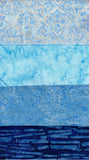 A stack of four blue patterned fabric swatches with different designs and textures, ranging from light blue batik to deep navy indigo.